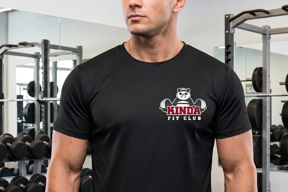 Man wearing a black t-shirt with a logo in a gym setting